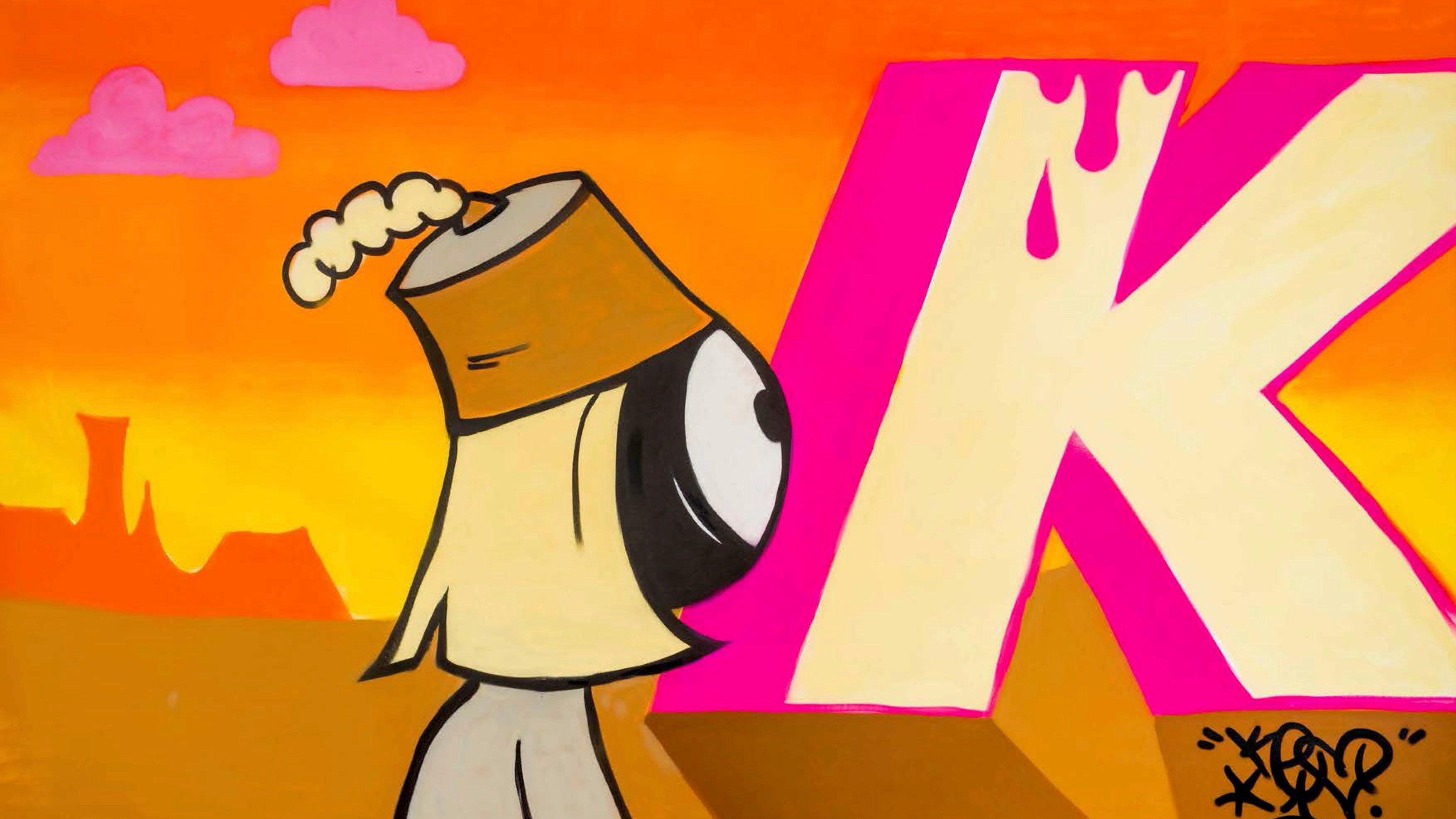 Cartoon character with a hat and a large 'K' in the background
